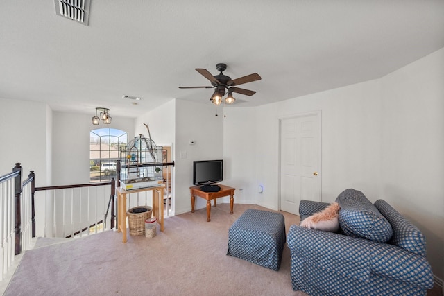 living area with a ceiling fan, carpet, visible vents, and baseboards