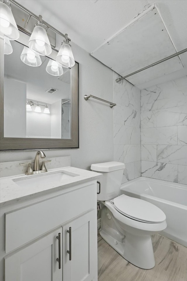 full bathroom with toilet,  shower combination, vanity, and visible vents