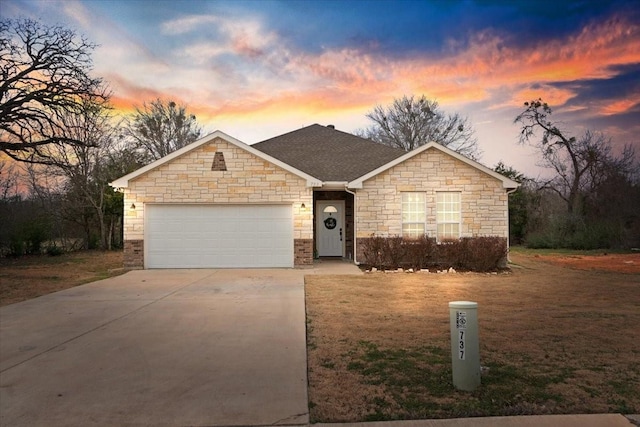 ranch-style house featuring a garage, roof with shingles, driveway, and a front lawn