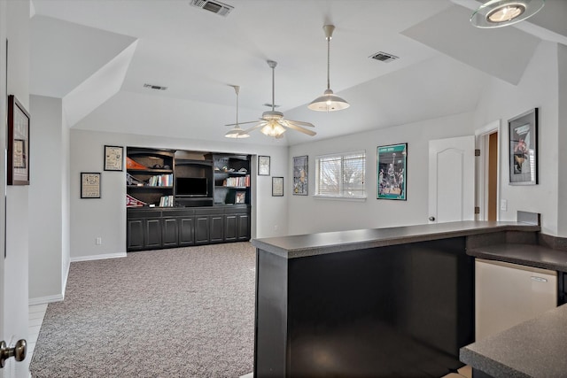 kitchen with dark countertops, carpet floors, and visible vents