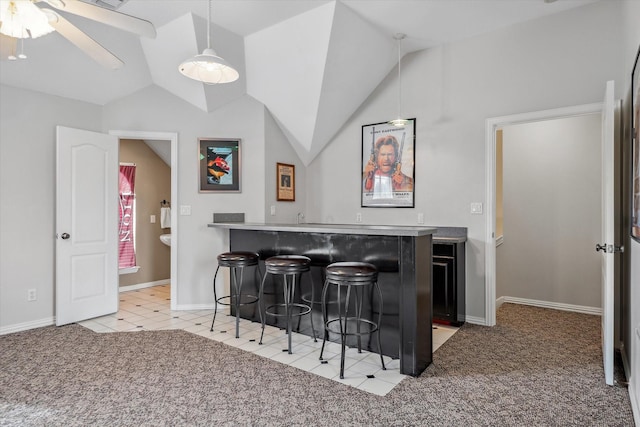 bar with wet bar, light carpet, vaulted ceiling, and decorative light fixtures