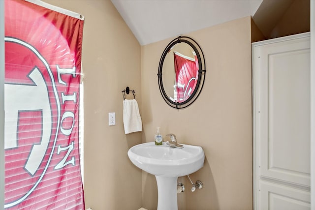 bathroom featuring lofted ceiling