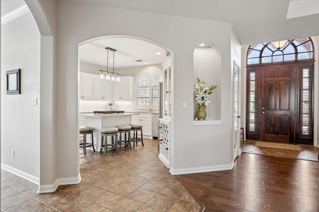 entrance foyer with baseboards and hardwood / wood-style flooring