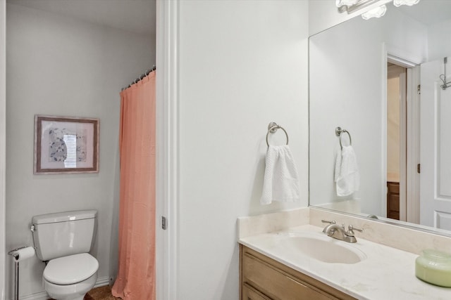 bathroom featuring toilet and vanity