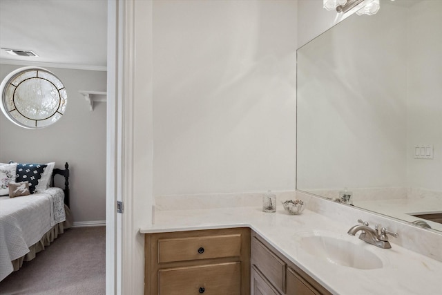 bathroom featuring visible vents, ornamental molding, and vanity