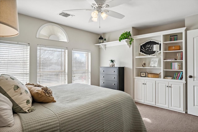 bedroom with visible vents, ceiling fan, and light carpet