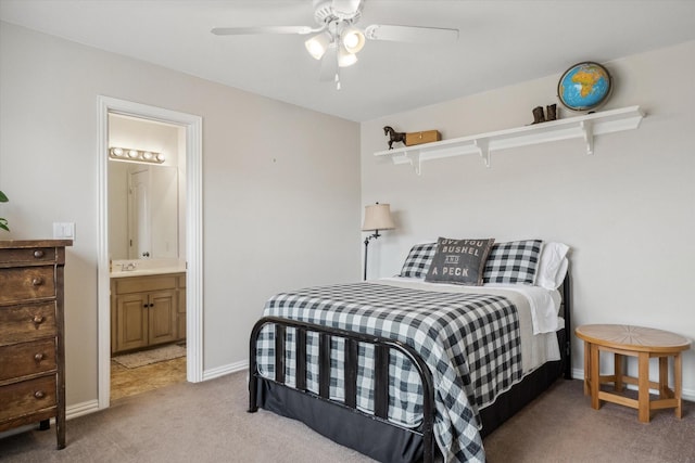 bedroom featuring ensuite bathroom, ceiling fan, baseboards, and light colored carpet