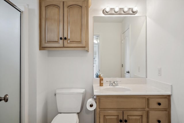 full bathroom with toilet, an enclosed shower, and vanity