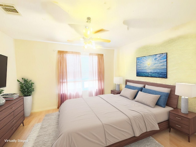 bedroom featuring light wood finished floors, baseboards, visible vents, and a ceiling fan