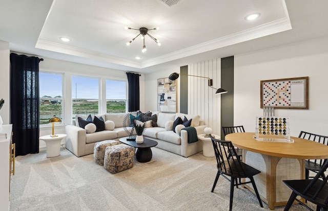 living area with light carpet, ornamental molding, and a raised ceiling