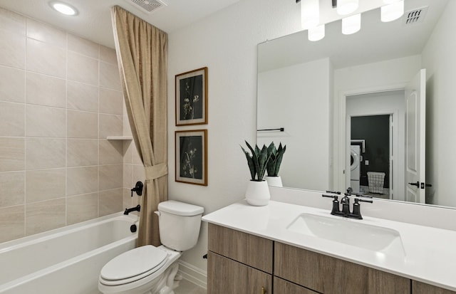 bathroom featuring toilet, vanity, visible vents, shower / bath combo, and washer / dryer