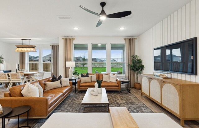 living room with recessed lighting, wood finished floors, visible vents, and a ceiling fan