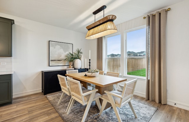 dining room with light wood-style flooring and baseboards