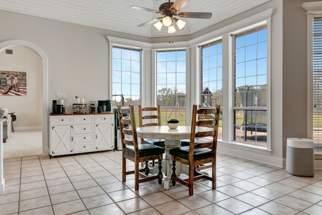 dining space with a ceiling fan, light tile patterned floors, and plenty of natural light