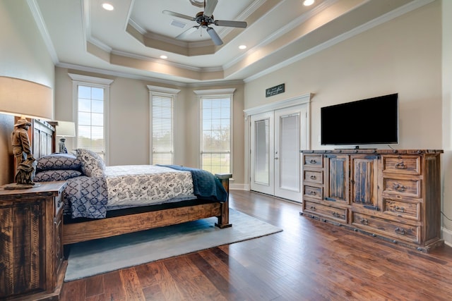 bedroom featuring wood finished floors, recessed lighting, crown molding, and a raised ceiling
