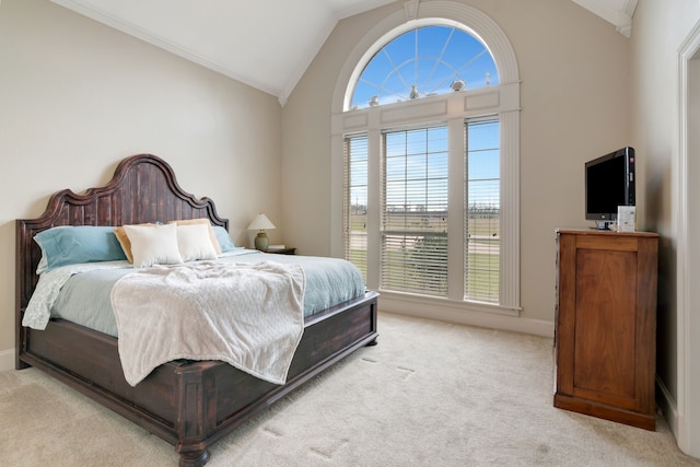 carpeted bedroom featuring baseboards, vaulted ceiling, and ornamental molding