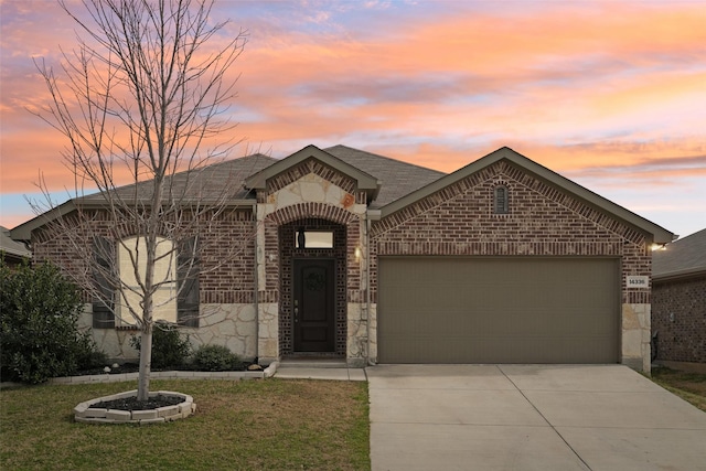 view of front of property featuring brick siding, a shingled roof, concrete driveway, a garage, and stone siding