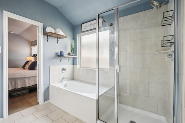 full bath with lofted ceiling, tile patterned flooring, a garden tub, a stall shower, and ensuite bath