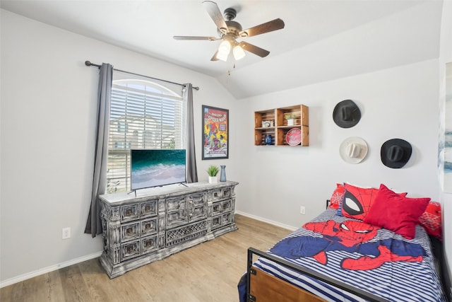 bedroom featuring lofted ceiling, ceiling fan, baseboards, and wood finished floors