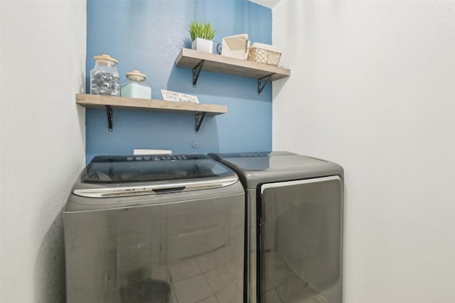 washroom featuring laundry area and washing machine and clothes dryer