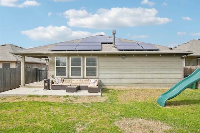 rear view of property with a yard, a patio, outdoor lounge area, and a playground