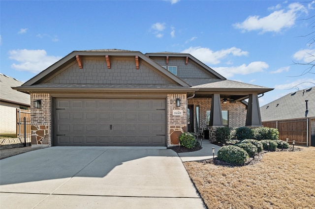 craftsman inspired home featuring driveway, a garage, covered porch, fence, and brick siding