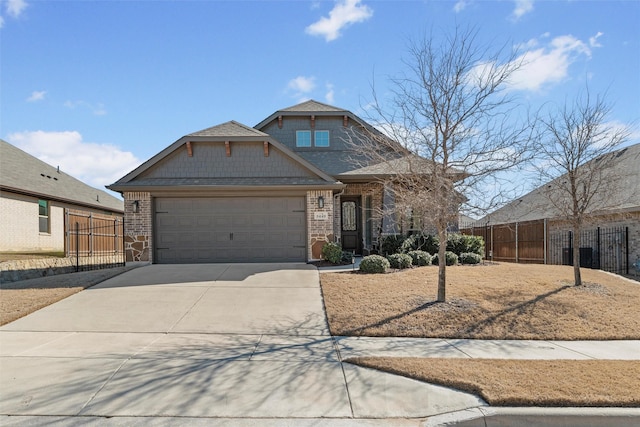 craftsman inspired home with driveway, brick siding, an attached garage, and fence