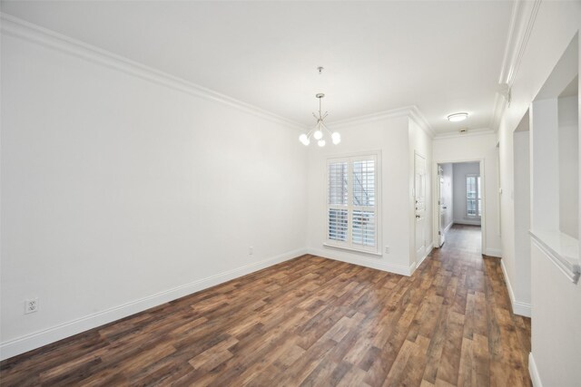 empty room with crown molding, baseboards, a chandelier, and dark wood-style flooring