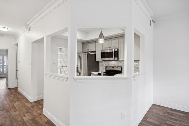 kitchen with appliances with stainless steel finishes, crown molding, backsplash, and dark wood-style floors