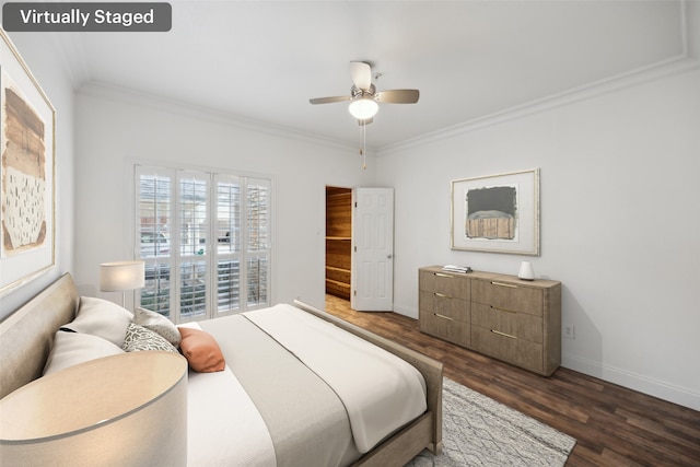 bedroom featuring ornamental molding, dark wood-style flooring, baseboards, and a ceiling fan