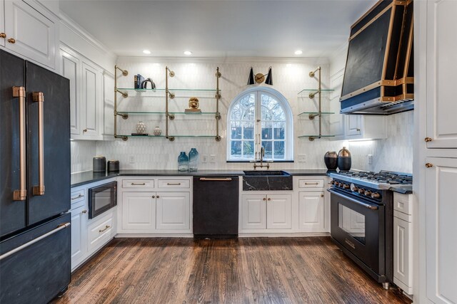 kitchen featuring dark countertops, black appliances, open shelves, a sink, and exhaust hood