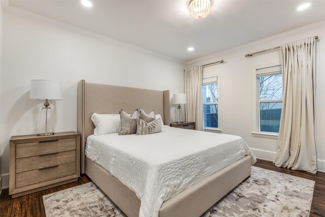 bedroom with dark wood-style floors, baseboards, crown molding, and recessed lighting