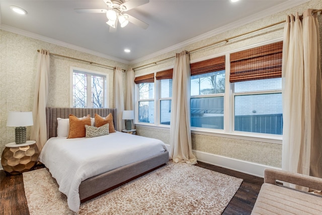 bedroom with ornamental molding, a ceiling fan, dark wood-type flooring, baseboards, and wallpapered walls