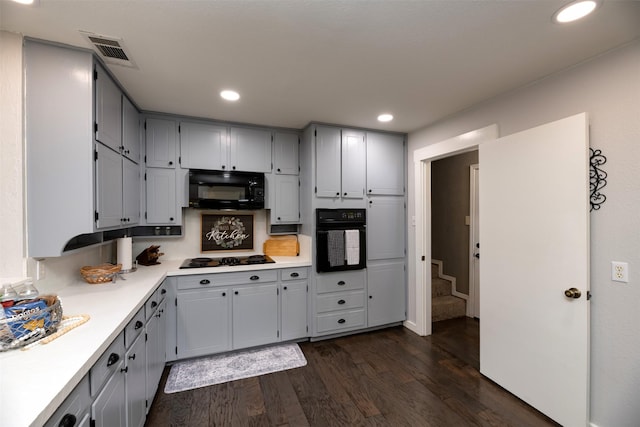 kitchen with recessed lighting, dark wood-type flooring, visible vents, light countertops, and black appliances