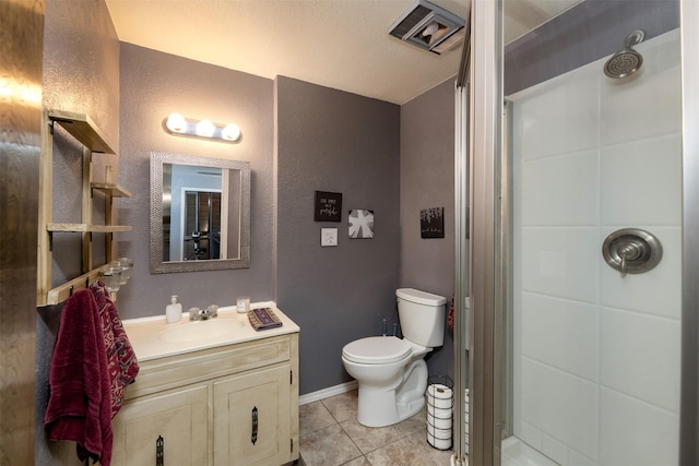 bathroom featuring baseboards, toilet, tile patterned floors, vanity, and a shower stall