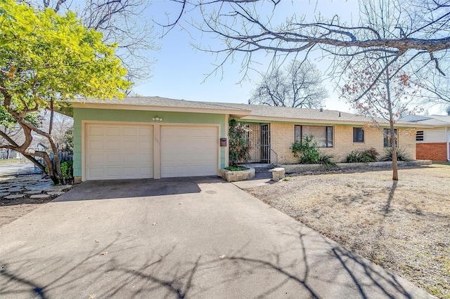 ranch-style house featuring driveway, brick siding, and an attached garage