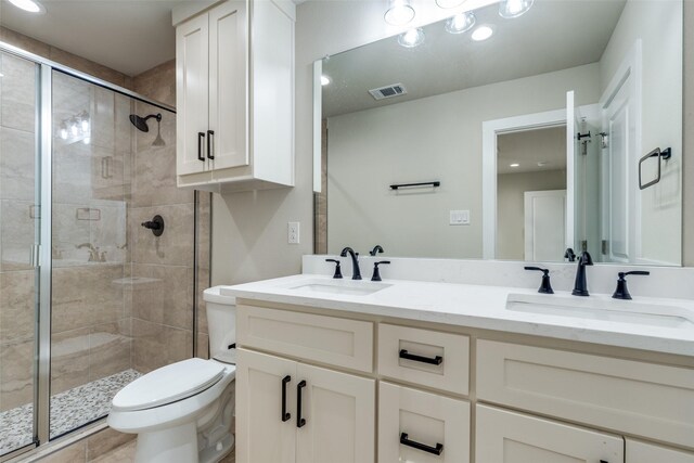 full bath featuring a stall shower, visible vents, a sink, and toilet