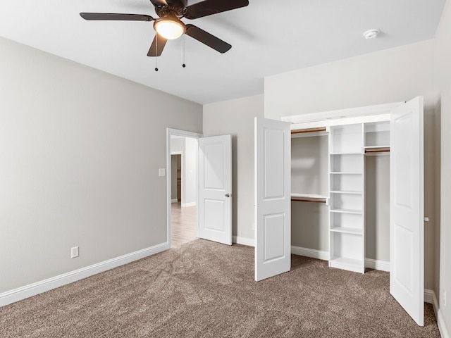 unfurnished bedroom with a ceiling fan, carpet, baseboards, and a closet