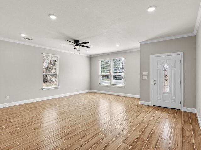 entrance foyer featuring ornamental molding, visible vents, light wood-style flooring, and baseboards