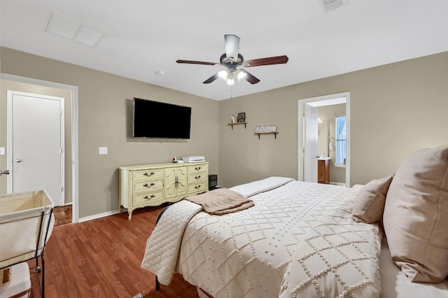 bedroom featuring baseboards, visible vents, ceiling fan, and wood finished floors