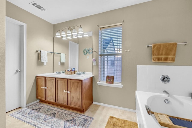 full bath with double vanity, baseboards, visible vents, a garden tub, and a sink