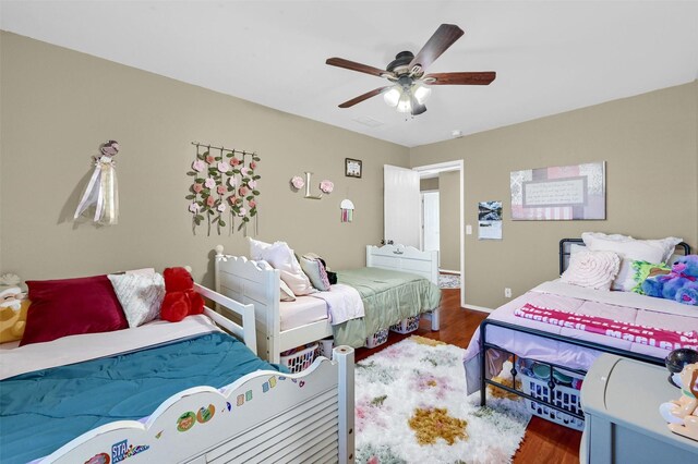 bedroom with ceiling fan and wood finished floors