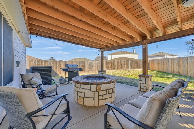 view of patio featuring an outdoor living space with a fire pit, grilling area, and a fenced backyard