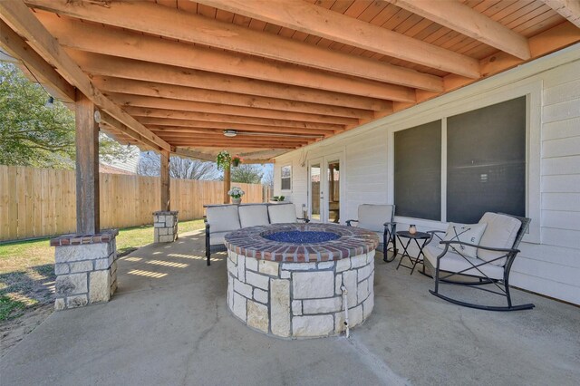 view of patio / terrace featuring a fire pit and fence