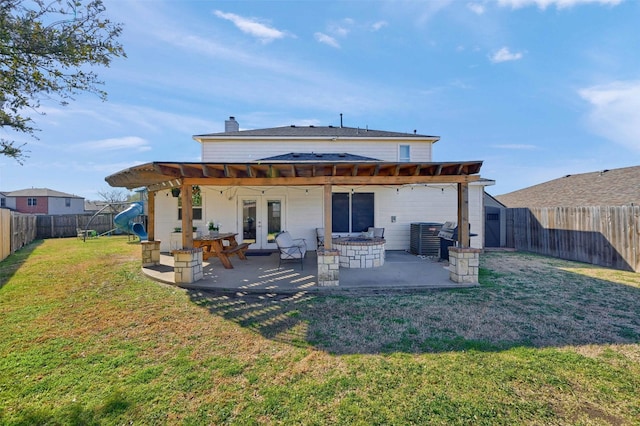 back of house with french doors, a yard, a chimney, a patio, and a fenced backyard