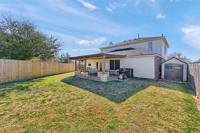 back of property featuring an outbuilding, a storage unit, a patio area, and a fenced backyard