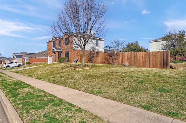 view of yard featuring a garage and fence