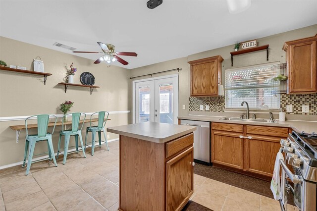 kitchen with tasteful backsplash, visible vents, appliances with stainless steel finishes, french doors, and a sink