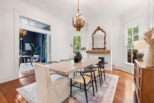 1502 W Virginia St, Mckinney, TX 75069 - dining space with hardwood / wood-style floors, a chandelier, ornamental molding, and baseboards