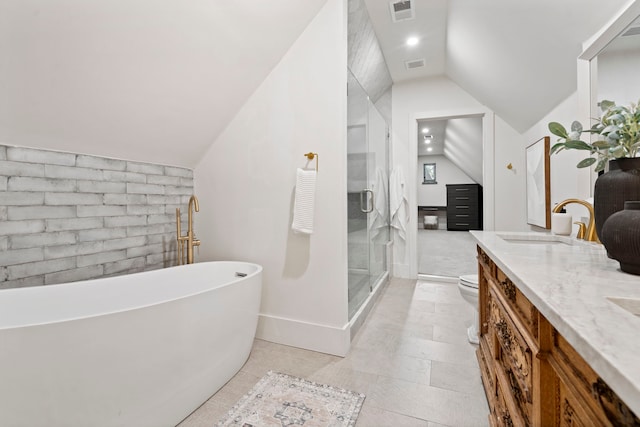 1502 W Virginia St, Mckinney, TX 75069 - bathroom with vaulted ceiling, double vanity, a stall shower, toilet, and a freestanding tub